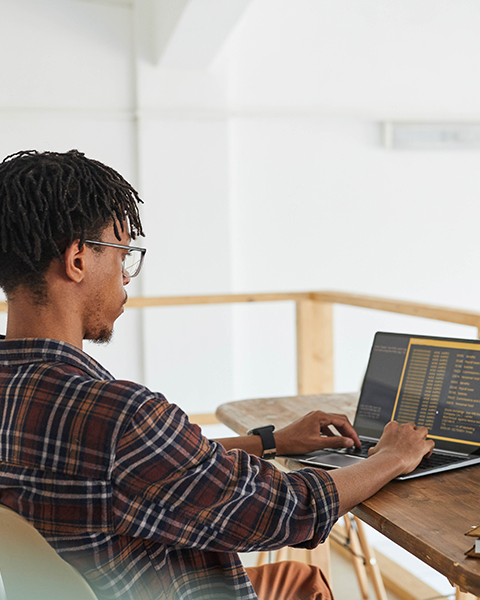man sitting working on a laptop 