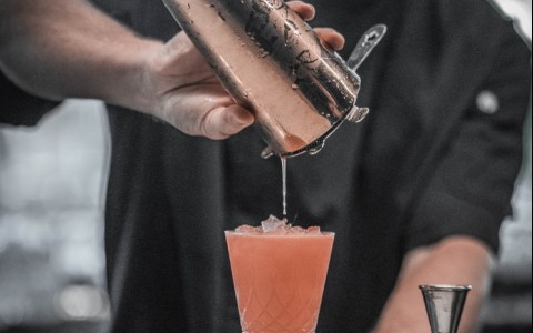 Man pouring a craft cocktail 