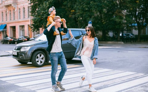 a family crossing the street