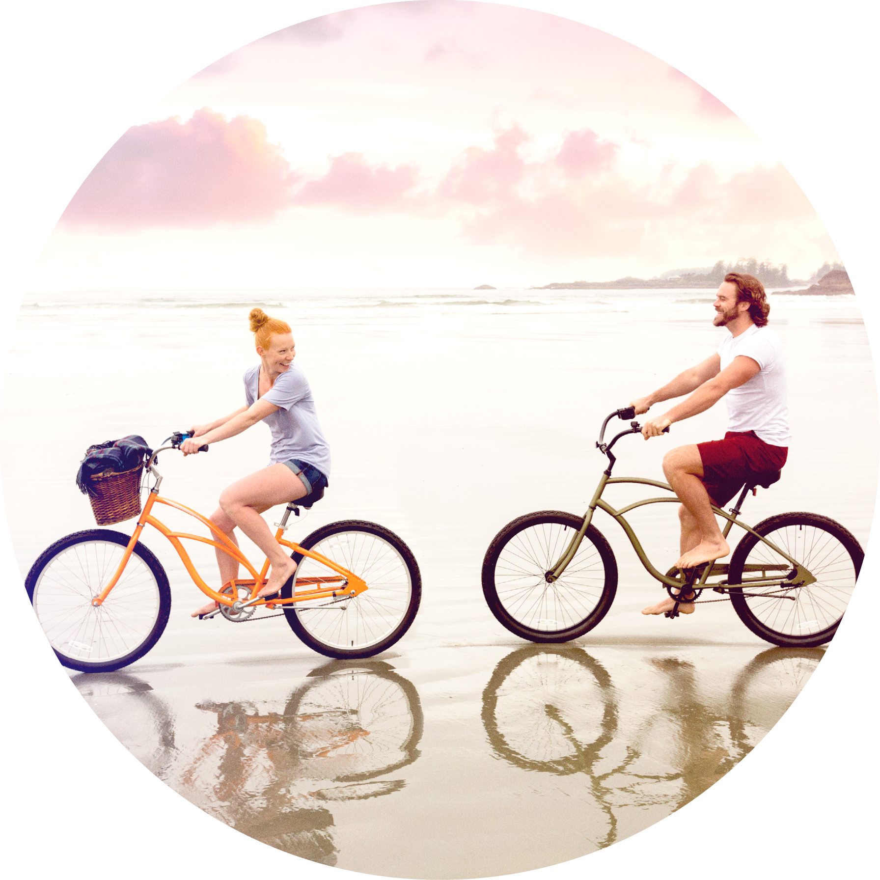man and woman riding bicycles along shoreline