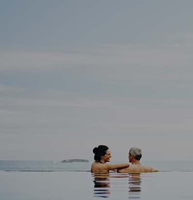 couple standing at edge of infinity pool