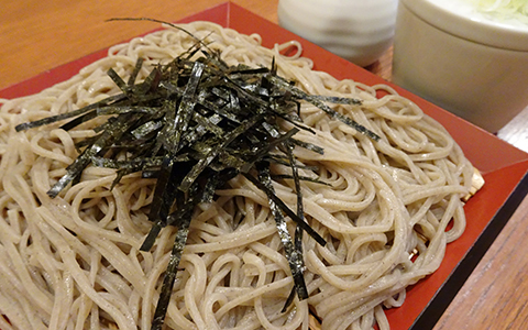 Freshly made soba noodles topped with chopped seaweed