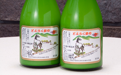 Bottles of Doburoku Koshin with brand labels on the front