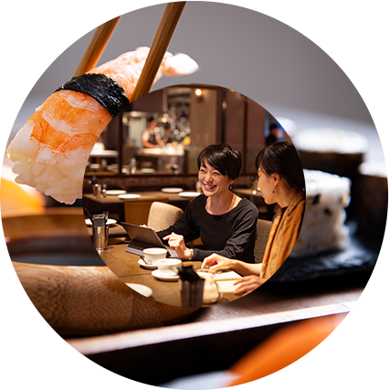 two women sitting in a booth at a restaurant smiling