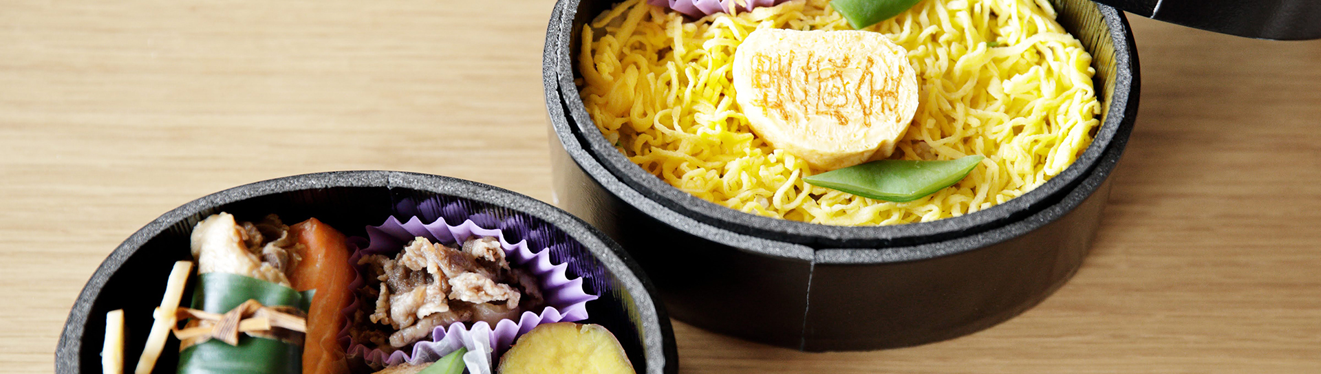 a bowl of noodles next to a bowl of various foods