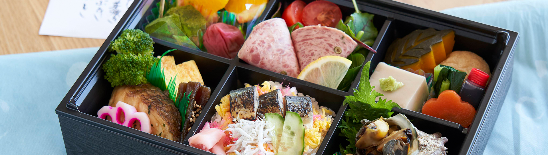 colorful japanese dish filled with various foods