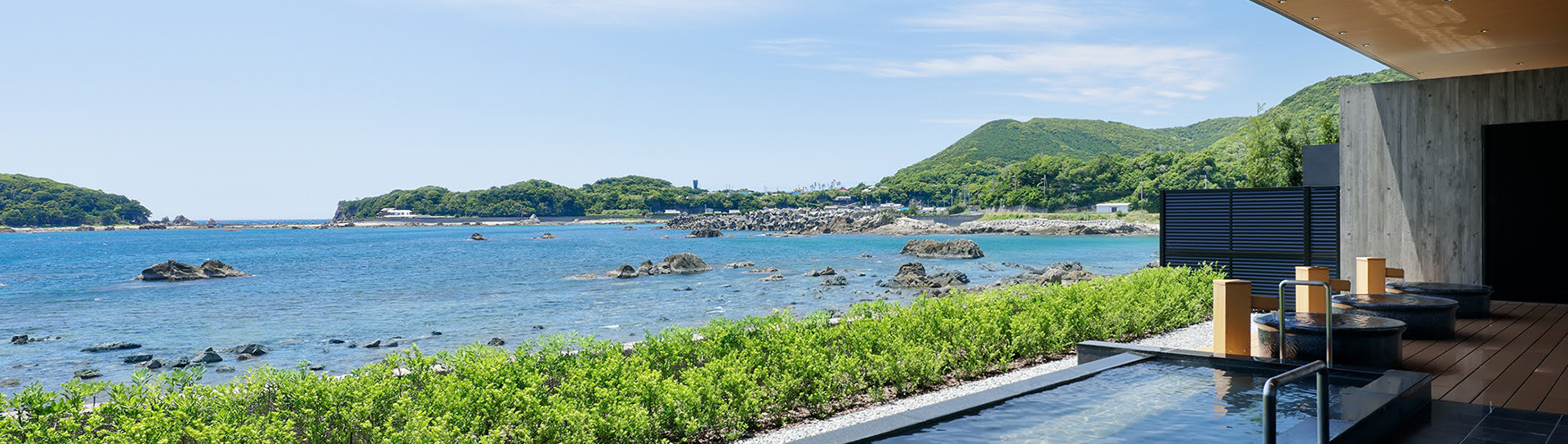 panoramic view of ocean with mountains in the background