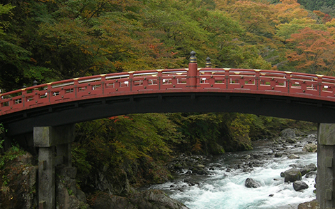 The red Shinkyo Bridge standing over a river