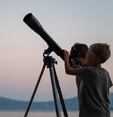 Two Kids looking into a telescope