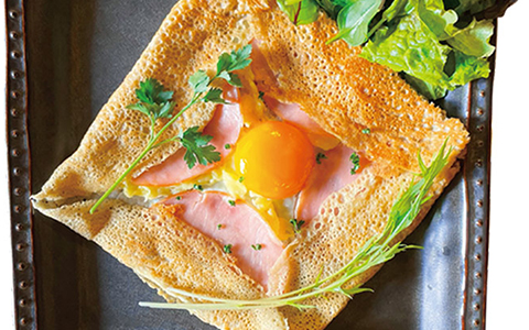 A crepe topped with ham and egg