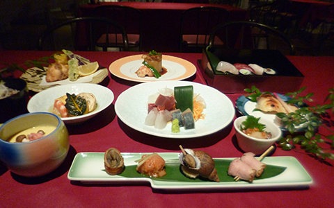 A seafood course meal with sashimi and grilled fish