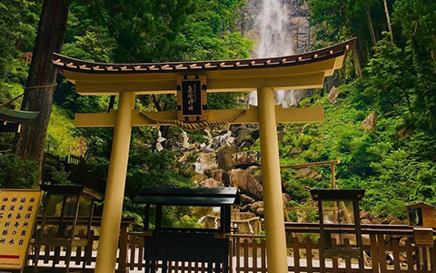 A shrine standing in front of the Nachi waterfall