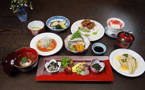 Plates of Japanese dishes including sashimi and miso soup