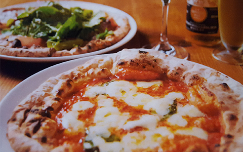 Two types of pizza served on a white plate