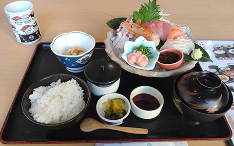 A Japanese set meal with sashimi, rice, and miso soup