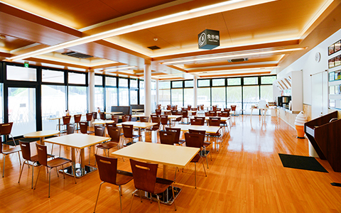 Interior of Tamba Daishokudo with white tables and wooden chairs for guests