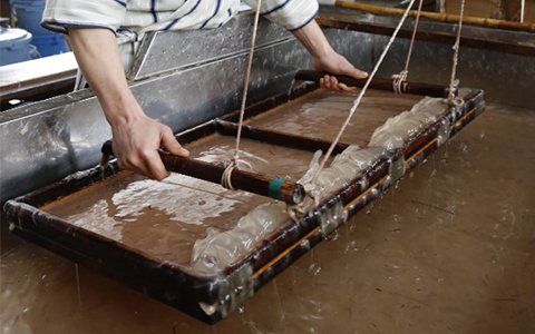 A craftsman making washi paper