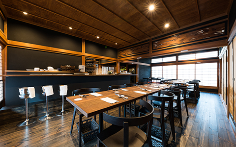Interior of Aceto with wooden tables, chairs, and counter seating