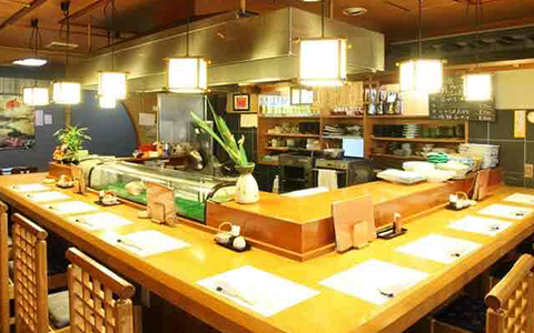 Interior of Japanese restaurant Tango with counter seats surrounding the kitchen