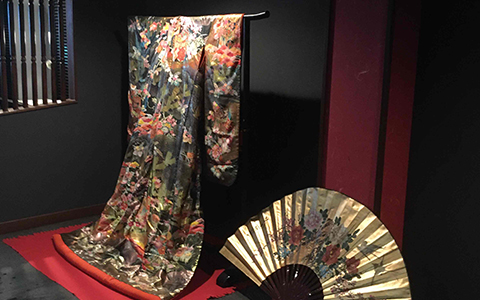 A kimono and Japanese fan displayed inside restaurant Kiki