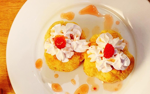 A dessert plate topped with whip cream
