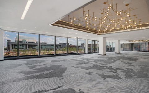 large open meeting space with carpet and windows surrounded