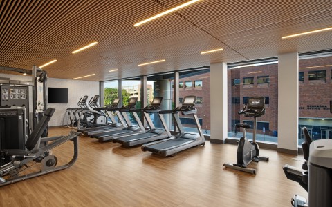fitness room with treadmills and peloton bike