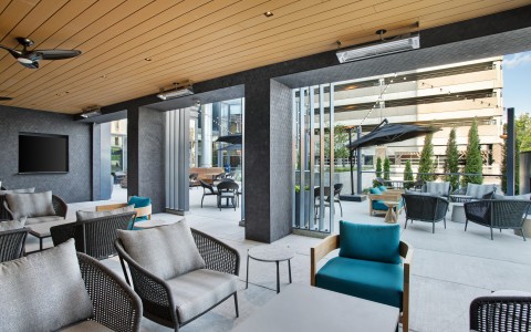 hotel outside patio with twinkling lights and multiple gray chairs