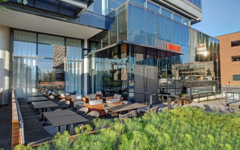 outdoor seating with plants and glass building