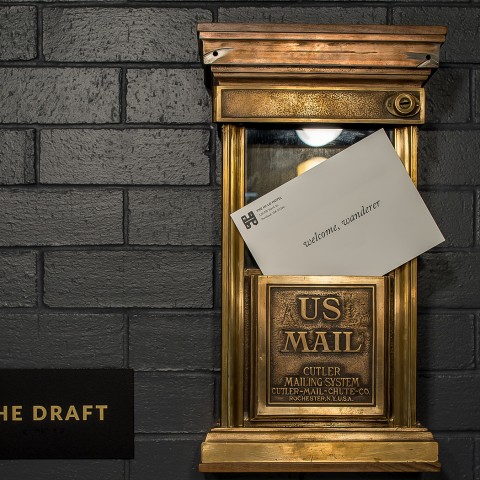 A US Mail golden box with a letter on it. 