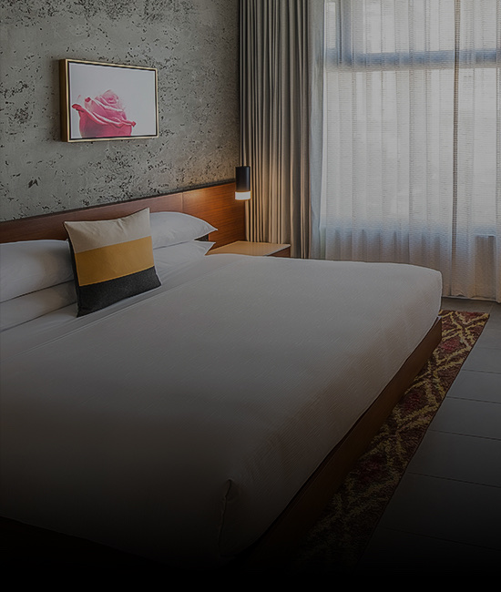Close up of a large bed with a decorative pillow