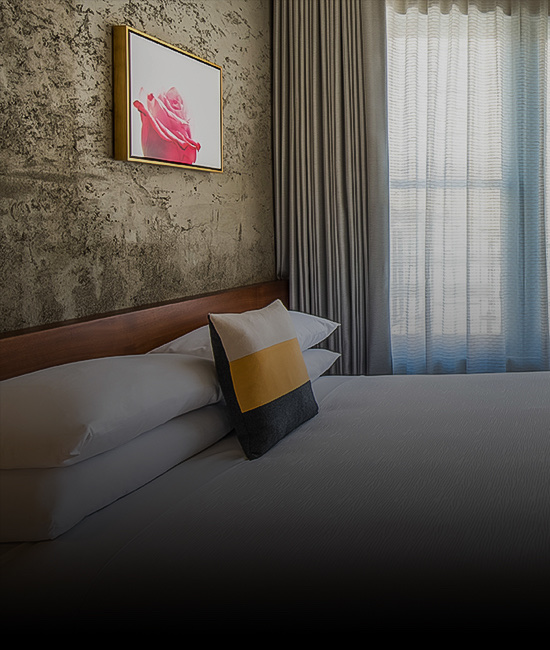 Bedroom with a patterned wall and and a painting