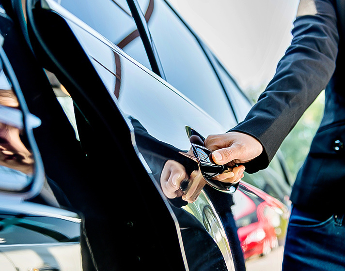 A man opening the door of a car