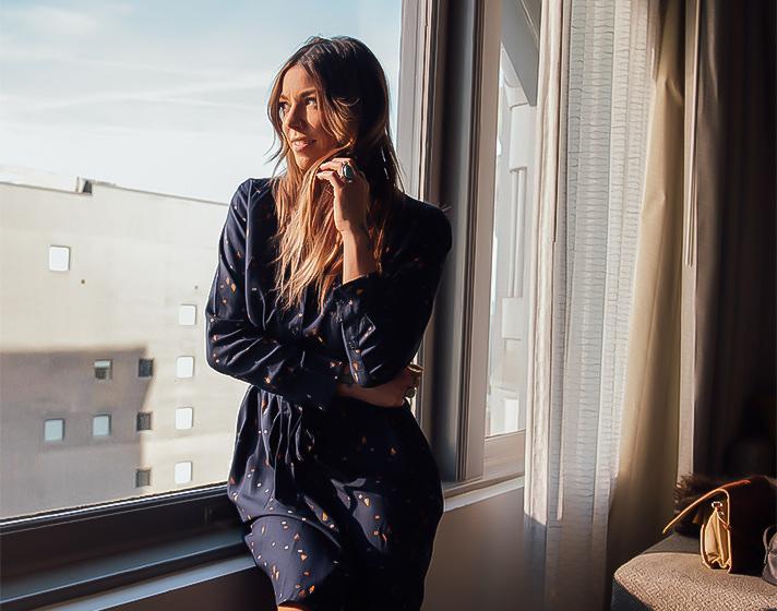 A woman looking out the room's window