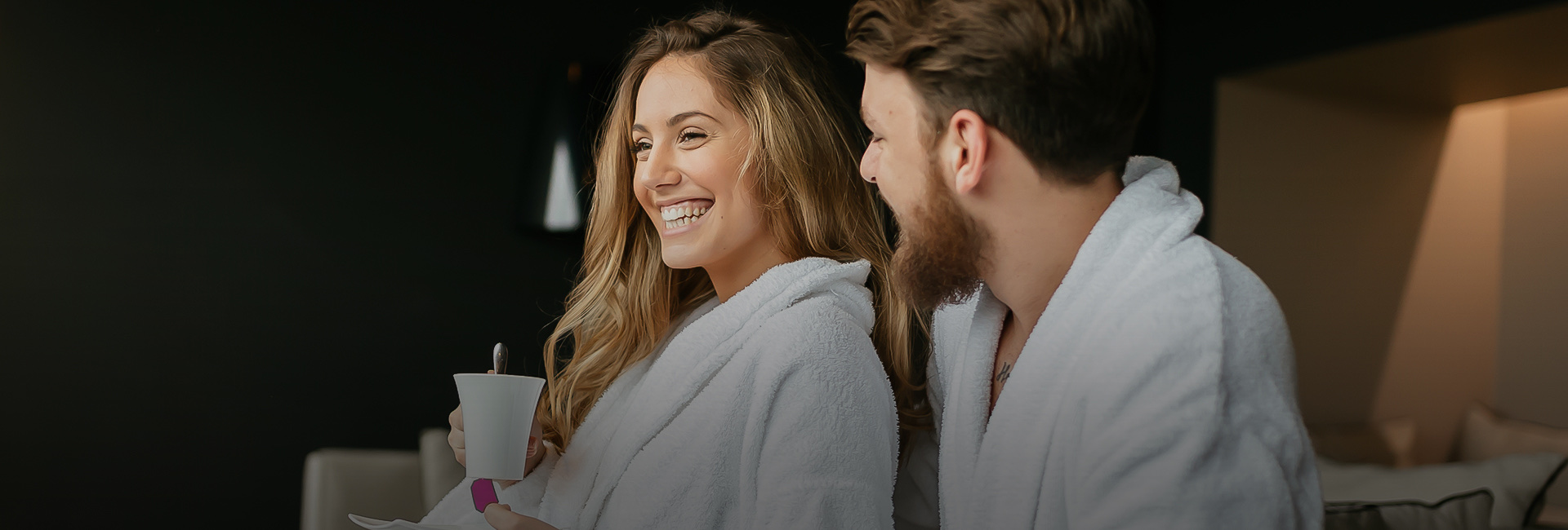A woman and a man on robe laughing