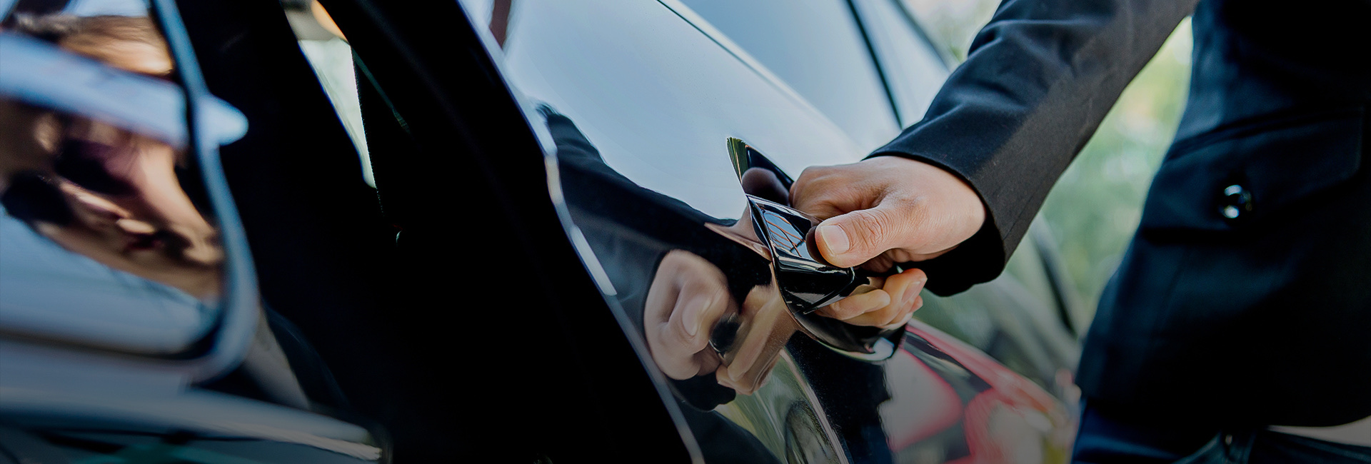 A man opening the door of a car