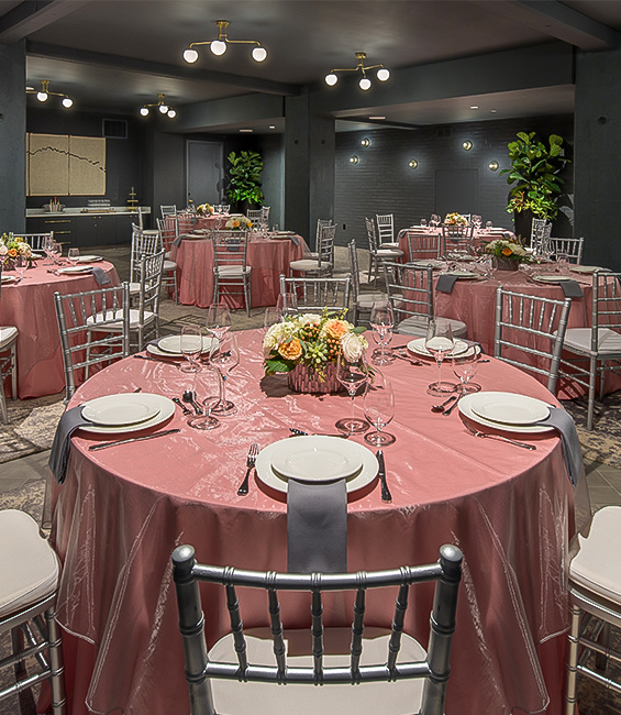 A dinning room with tables and plates.