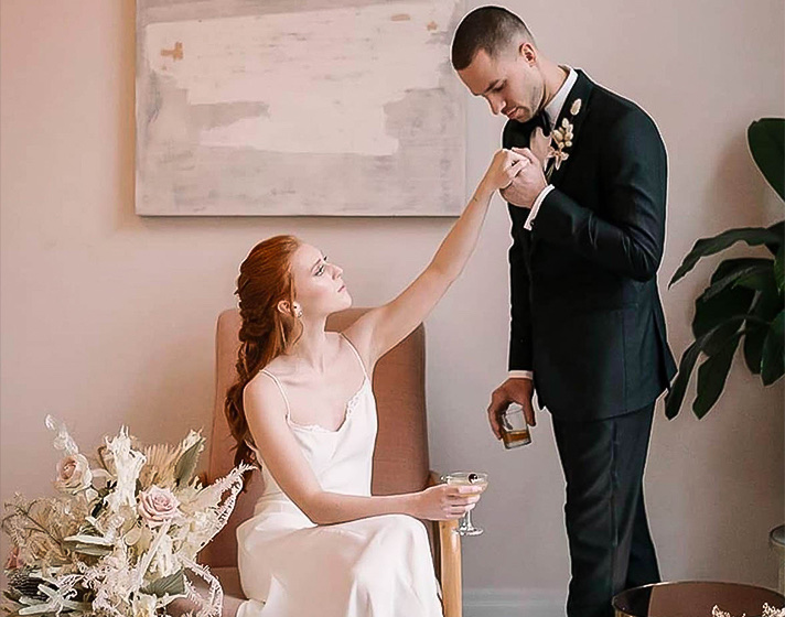 A man holding the hand of his bride