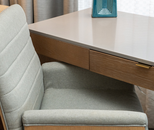 A desk with a drawer and a chair.