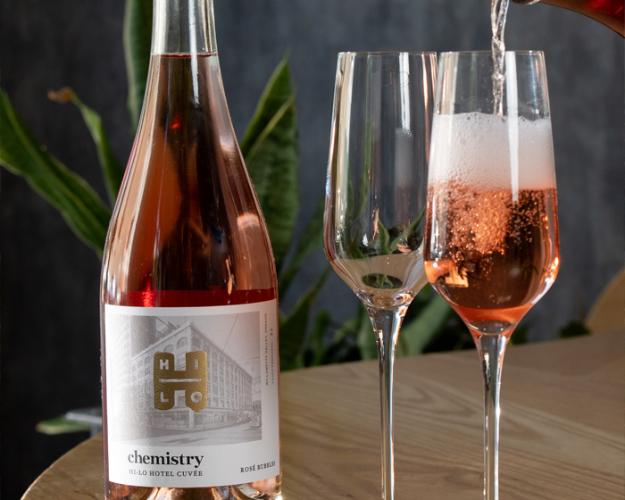 close up of rose wine bottle and two glasses