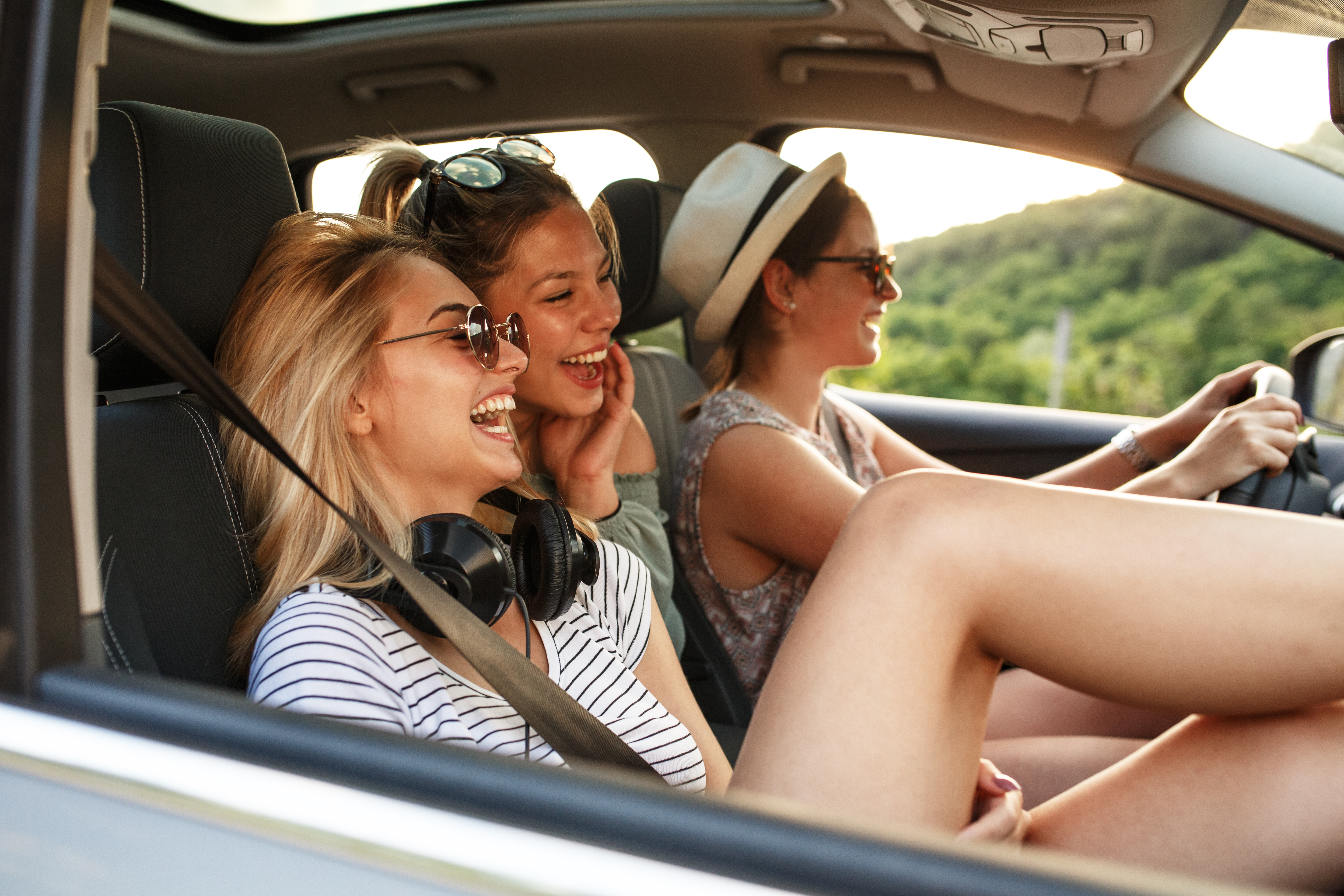 women driving in a car and smiling