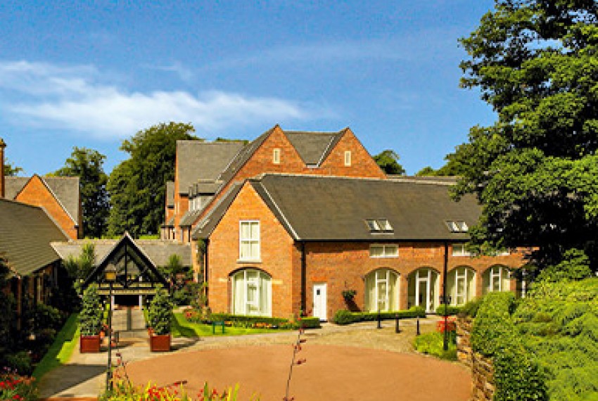 exterior view of worsleypark with many plants around it and a clear sky