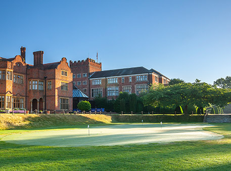 exterior view of property with a main small golf course and a clear sky