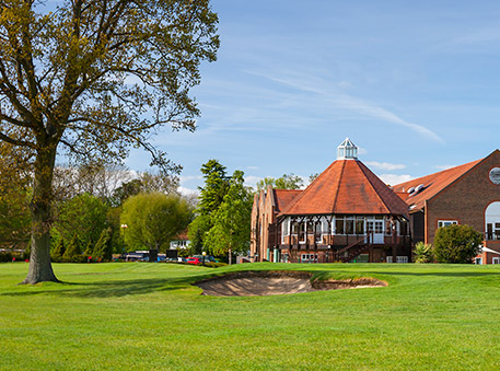 exterior view of property with a main hole and a sky with the softest accents of white.