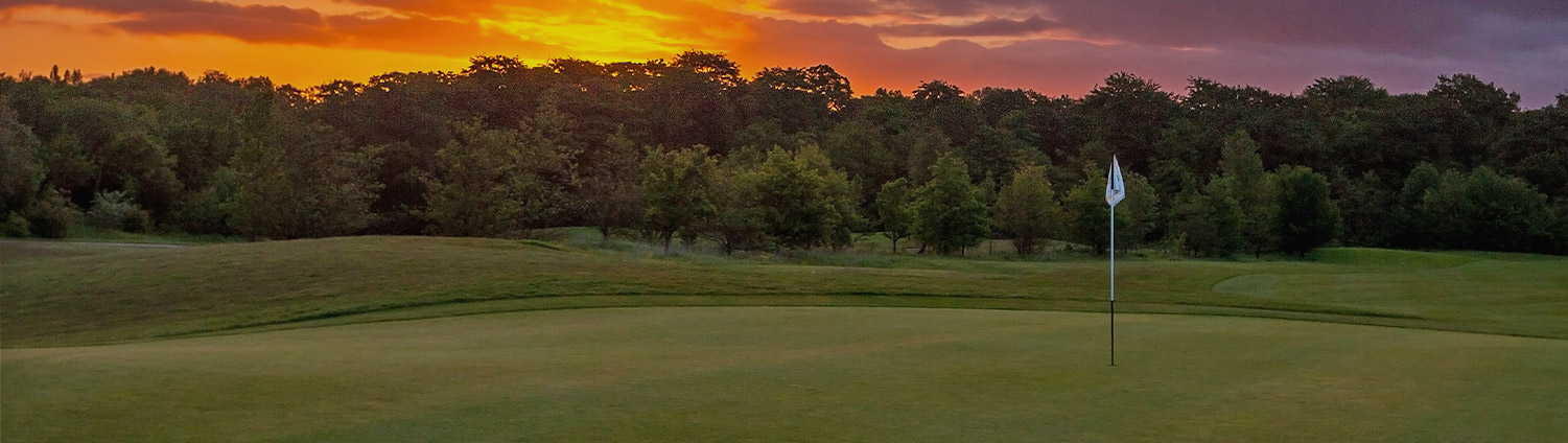 view of golf course during sunset