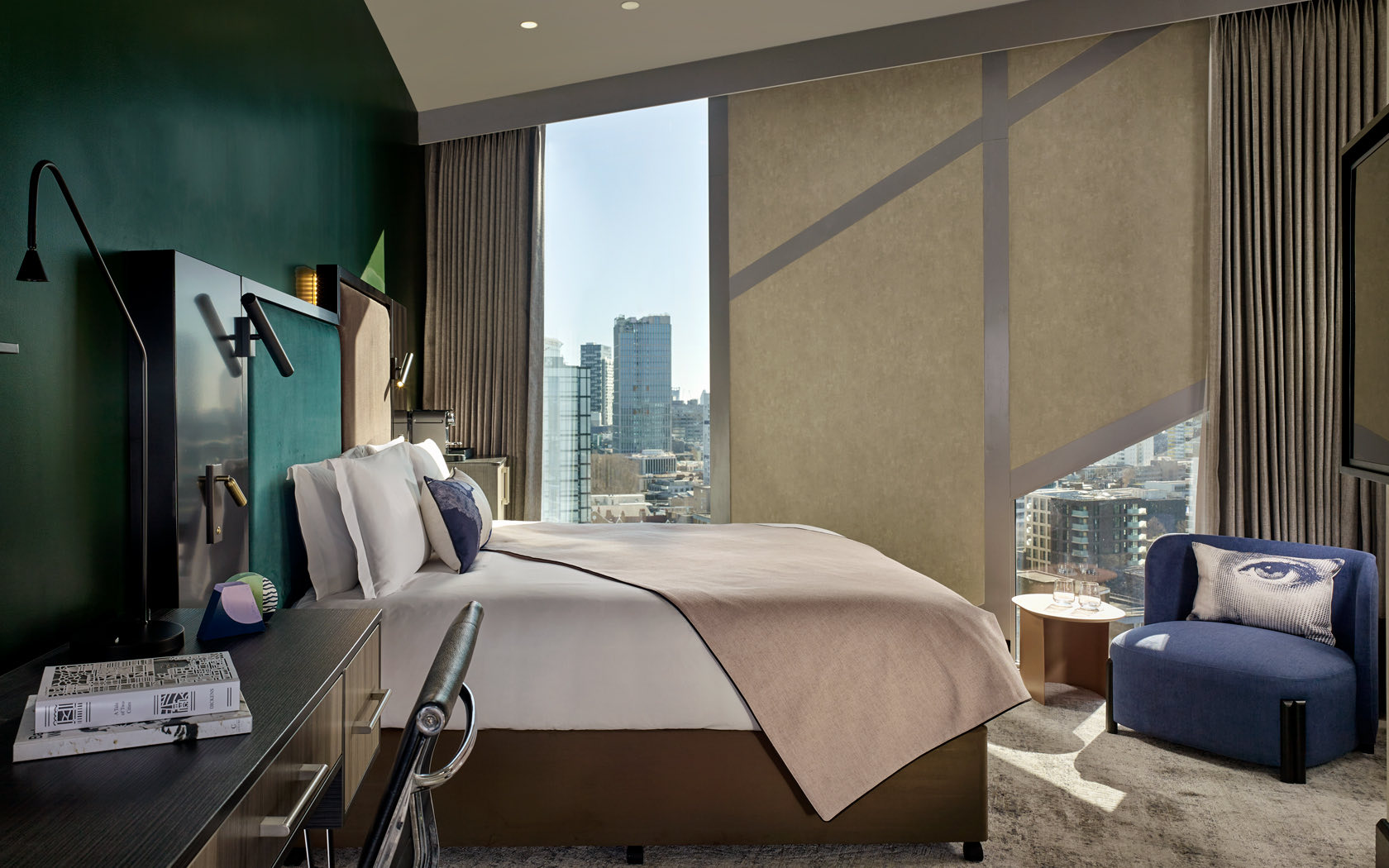 king bed in large spacious room with window facing city