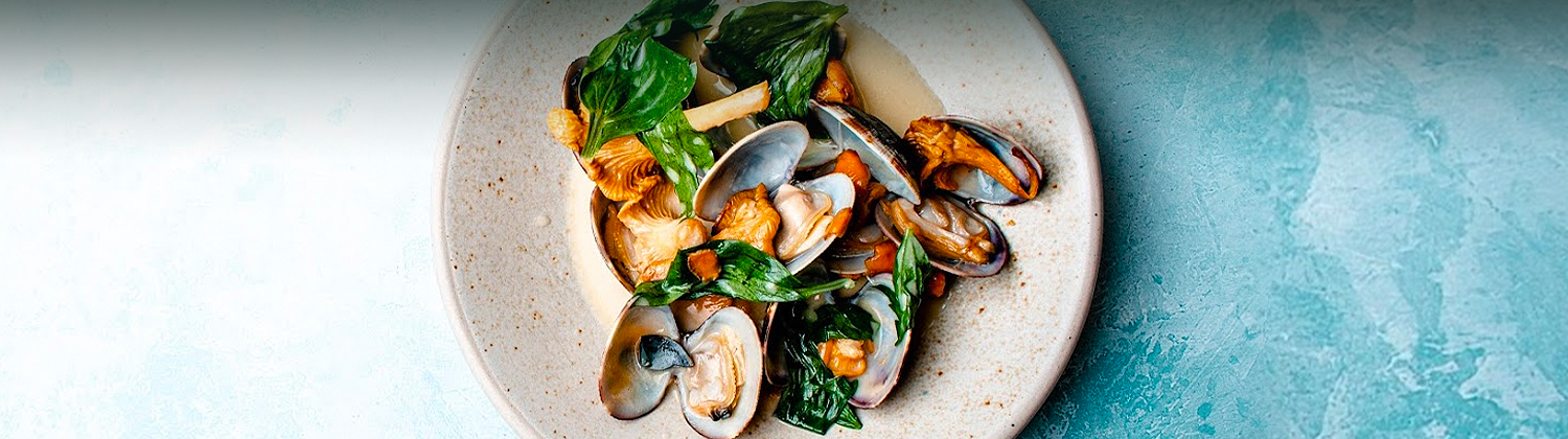 seafood dish with cooked greens and mushrooms