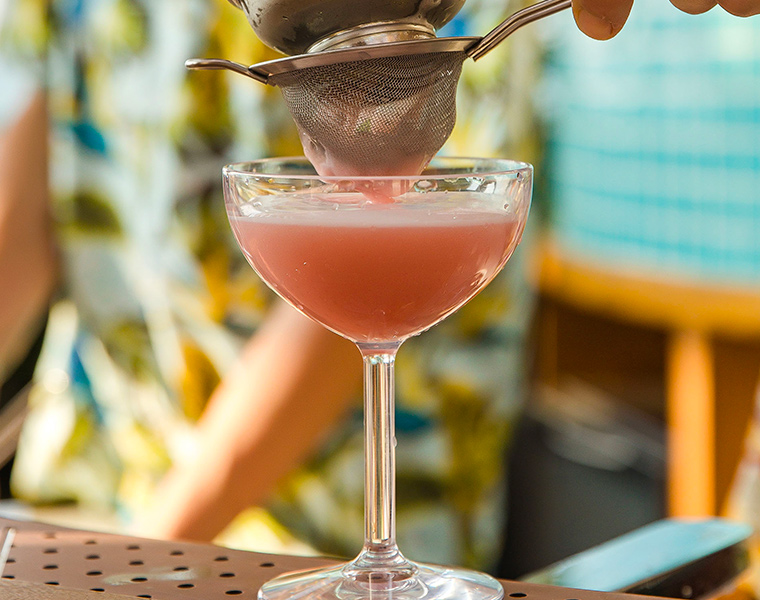 bartender making a pink drink