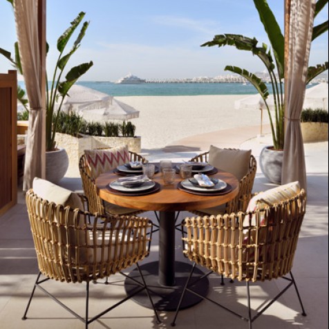 table for 4 outdoors with a beach view
