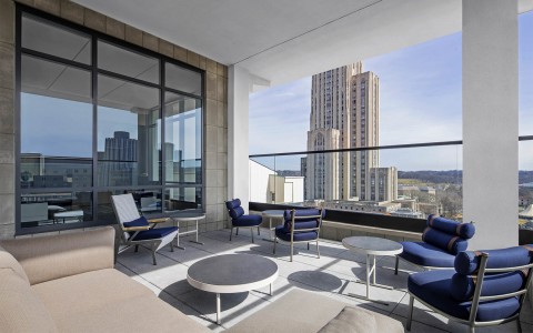 a balcony with outdoor seating and the sun shining